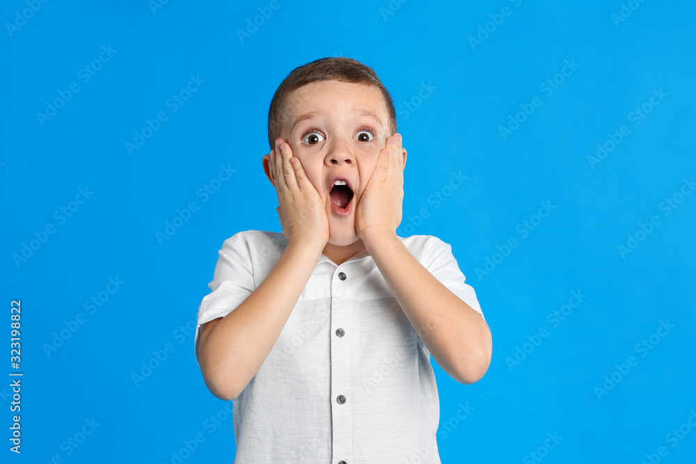 Portrait of emotional little boy on blue background Portrait of emotional little boy on blue background