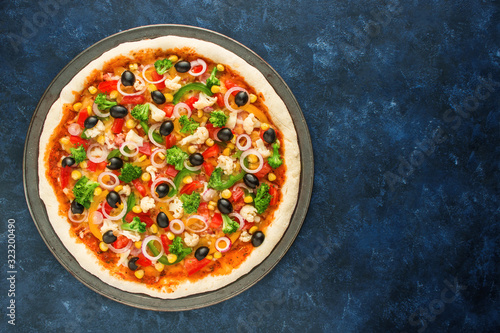 healthy vegetarian pizza with vegetables on dark blue background  top view copy space