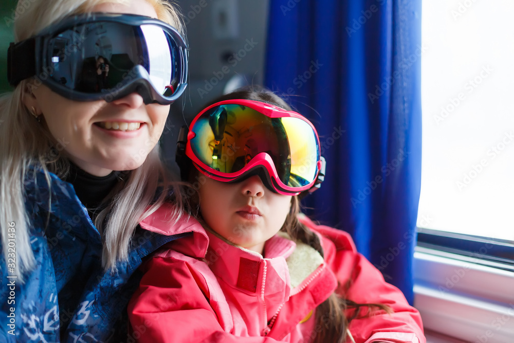 Mother and daughter skiing in the mountain Mother and daughter skiing in the mountain