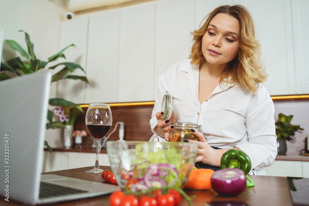 Attractive plump girl cooking with video guide