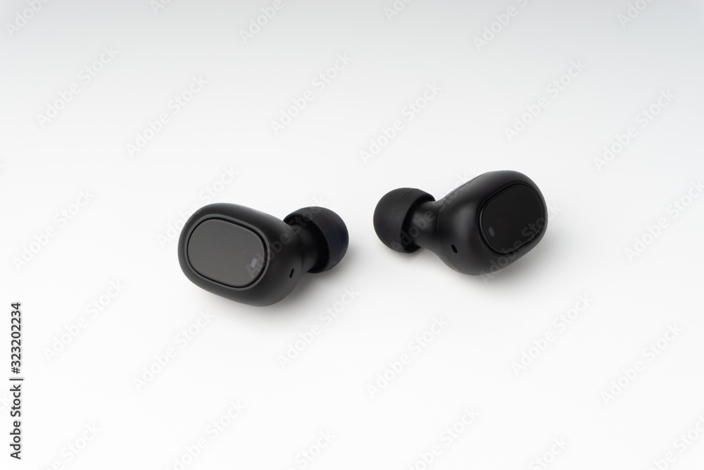 Wireless earbuds or earphones on white background. Copy space and technology concept Wireless earbuds or earphones on white background. Copy space and technology concept
