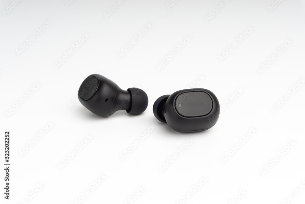 Wireless earbuds or earphones on white background. Copy space and technology concept Wireless earbuds or earphones on white background. Copy space and technology concept