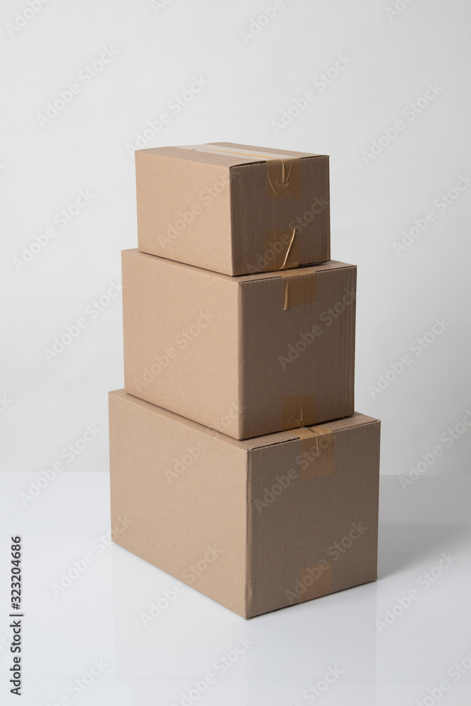 Pile of various size taped up cardboard boxes Pile of various size taped up cardboard boxes