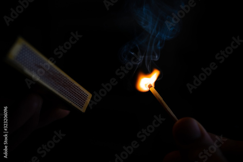The flame and smoke when lighting a safety match