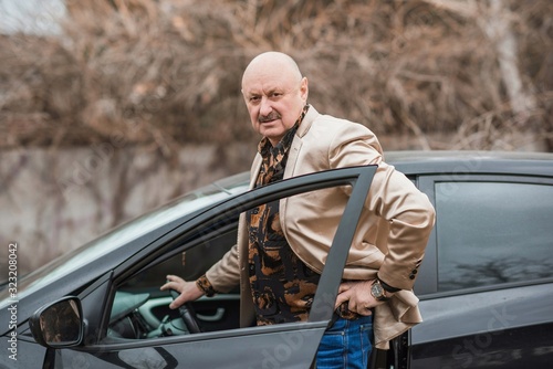 Mature senior man in automobile, older man lifestyle	 
