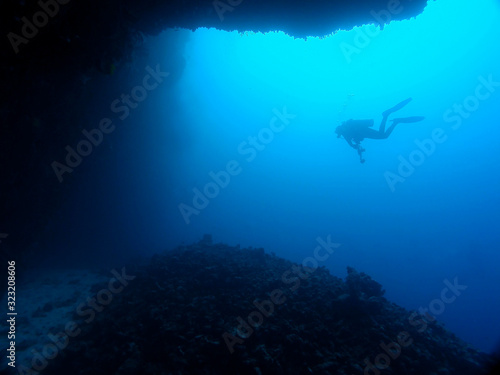 Silhouette of scuba diver from cave. Great Barrier Reef Australia.