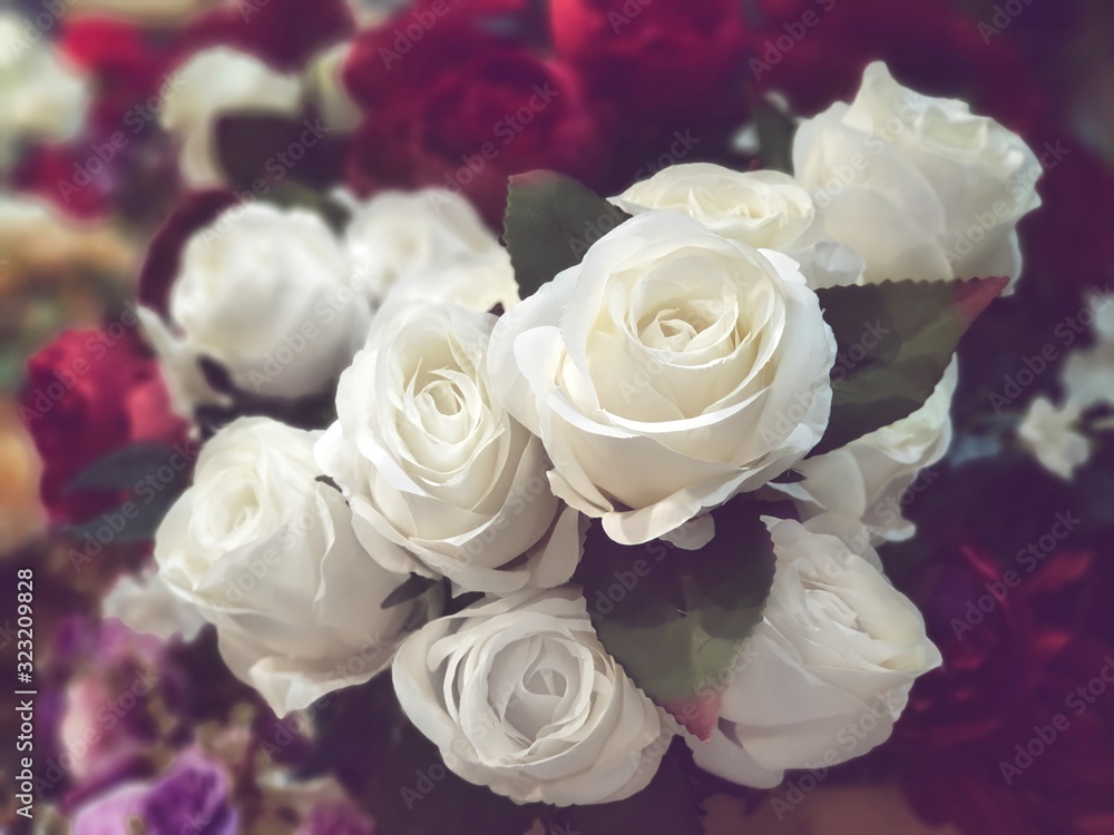 Obraz premium Fake flowers for Interior.Artificial roses made by fabric and plastic use decorated.14 February is Valentine day. love wallpaper.White roses bouquet in a vase