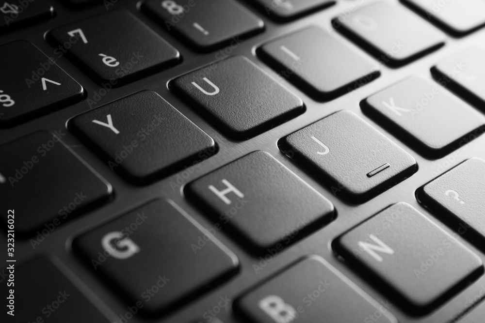 Laptop keyboard close-up in black and white with selective focus and brushed aluminium Laptop keyboard close-up in black and white with selective focus and brushed aluminium