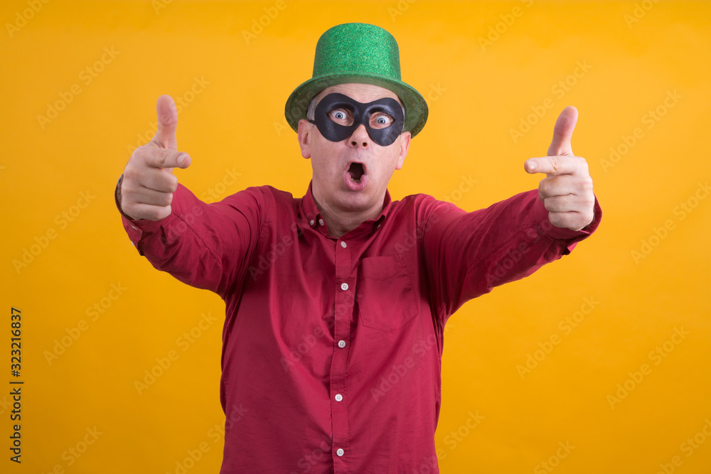 smiling man with black mask, and hat making ok gesture, carnival concept smiling man with black mask, and hat making ok gesture, carnival concept