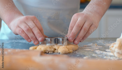 Girl making cookies with a cookie cutter