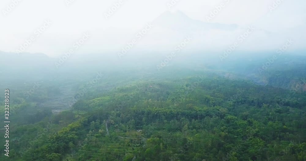 Lush tropical hills with misty mountain background Lush tropical hills with misty mountain background