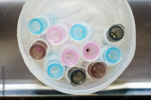 Used needles put together in a plastic cup