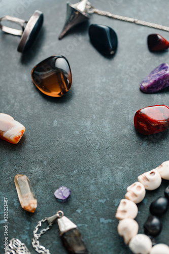 Magic flat lay. Various precious and semiprecious stones on a blue background for witchcraft. photo