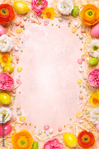 Frame with easter eggs  spring flowers and candy
