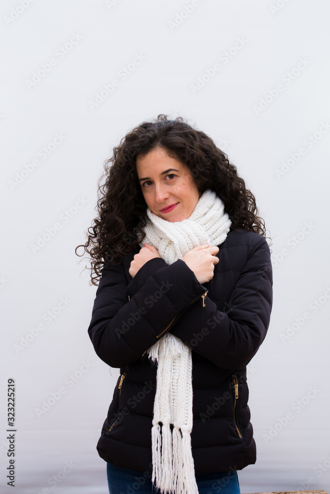 young pretty woman feeling in love, smiling, cuddling and hugging self, staying single, being selfish and egocentric against white wall young pretty woman feeling in love, smiling, cuddling and hugging self, staying single, being selfish and egocentric against white wall