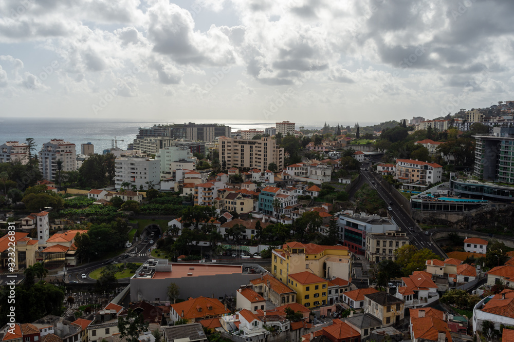 City of Funchal town on Madeira Portugal with horizon and a cloudy sky in background