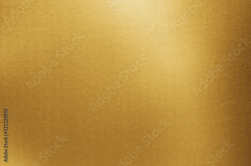 Gold paper texture background. Golden metallic blank paper sheet surface with light reflection