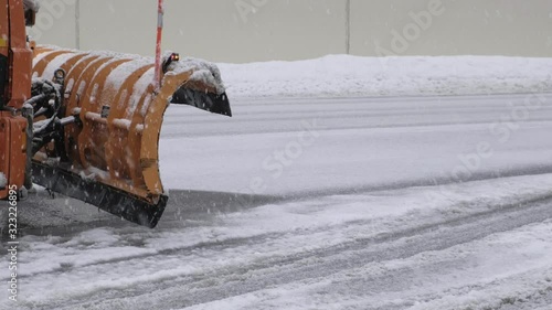 Sochi, Russia - 10.02.2020 The snowplow is orange. Snowfall. Ice. Safety on the road. Utilities. Blizzard. 