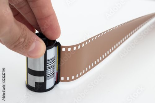 Old photographic 35 mm film with roll. Isolated on white background.