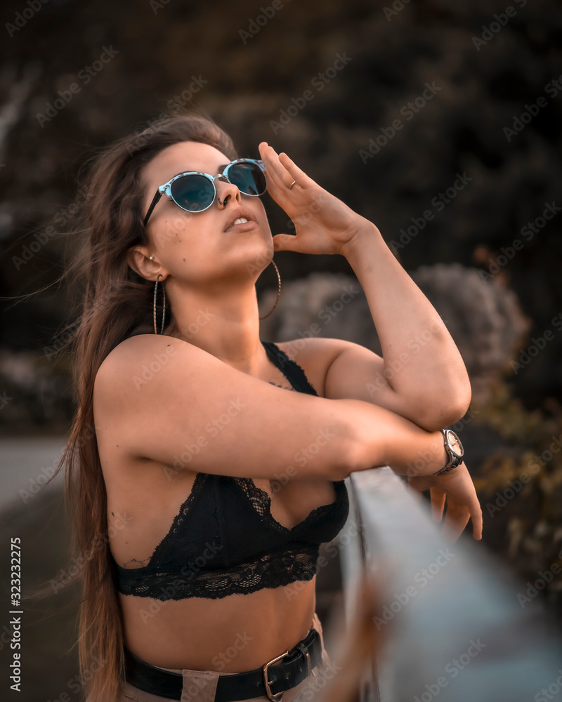A young woman with sunglasses smiling in a session A young woman with sunglasses smiling in a session