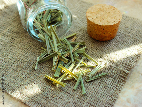 Lemon Grass (Cymbopogon citratus, Capim Limao, Santo). Pile of dried Lemongrass. Dried sprigs of natural lemongrass, dried herb, herbal medicine. Selective focus, closeup
