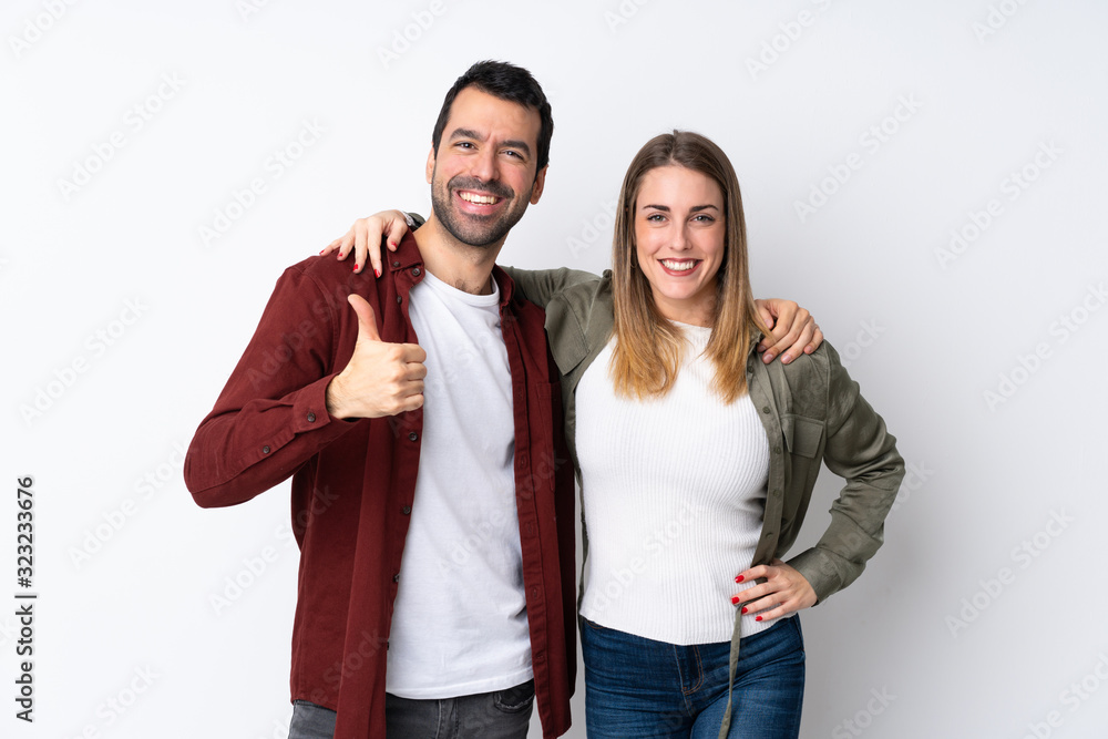 Couple in Valentine Day over isolated background giving a thumbs up gesture Couple in Valentine Day over isolated background giving a thumbs up gesture