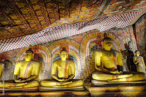 Buddha statue inside Dambulla cave temple on February 8, 2020 in Dambulla, Sri Lanka. Cave III Maha Alut Viharaya. Major attractions are spread over 5 caves, which contain statues and paintings.