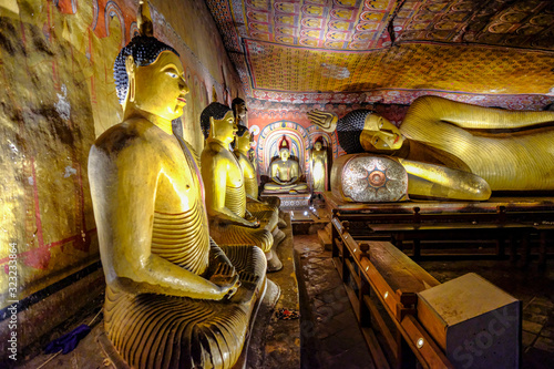 Buddha statue inside Dambulla cave temple in Dambulla, Sri Lanka. Cave III Maha Alut Viharaya. Major attractions are spread over 5 caves, which contain statues and paintings. photo
