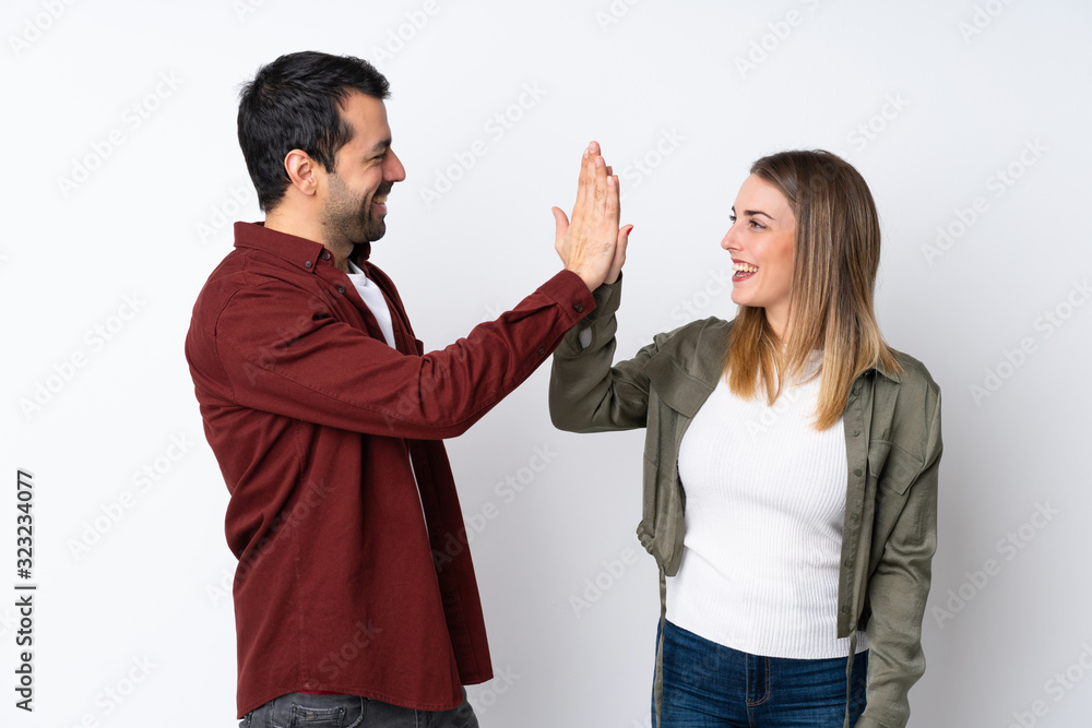 Couple in Valentine Day over isolated background bumping hands Couple in Valentine Day over isolated background bumping hands
