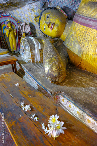 Buddha statue inside Dambulla cave temple in Dambulla, Sri Lanka. Cave V Devana Alut Viharaya. Major attractions are spread over 5 caves, which contain statues and paintings. photo