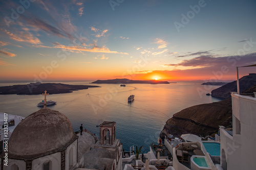 Amazing evening view of Santorini island. Picturesque spring sunset on the famous Greek resort Fira, Greece, Europe. Traveling concept background. Artistic style post processed photo. Summer vacation