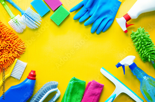 Colorfull cleaning items on yellow wooden