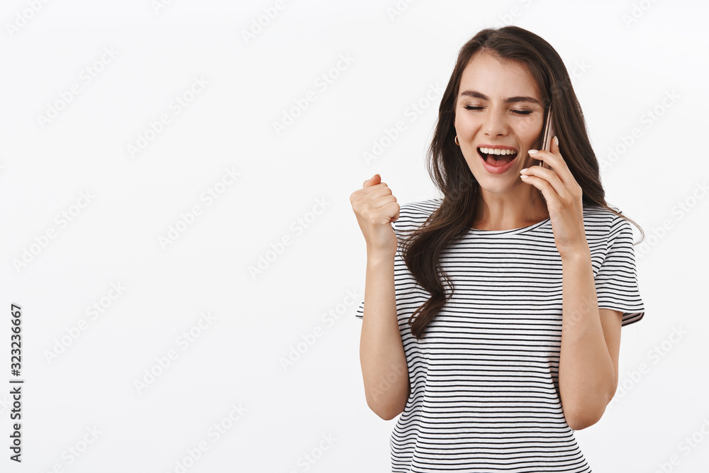 Yeah congrats. Happy rejoicing young woman calling friend, hear great news, achieve success, got permission, winning prize, being informed by phone call, holding smartphone over ear, cheering Yeah congrats. Happy rejoicing young woman calling friend, hear great news, achieve success, got permission, winning prize, being informed by phone call, holding smartphone over ear, cheering