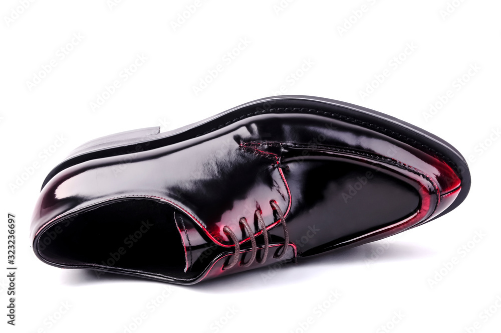 Fotografie Black leather shoes lying down in white background