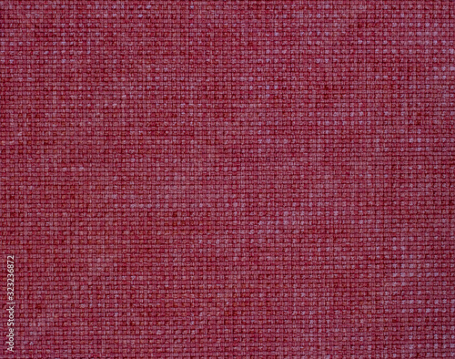 Textile texture background burgundy color. Fabric for furniture, bags, curtains, clothes. Flat lay. Copy Space. Close up.
