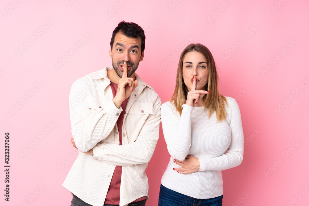 Φωτογραφία Couple in Valentine Day over isolated pink background showing a sign of silence