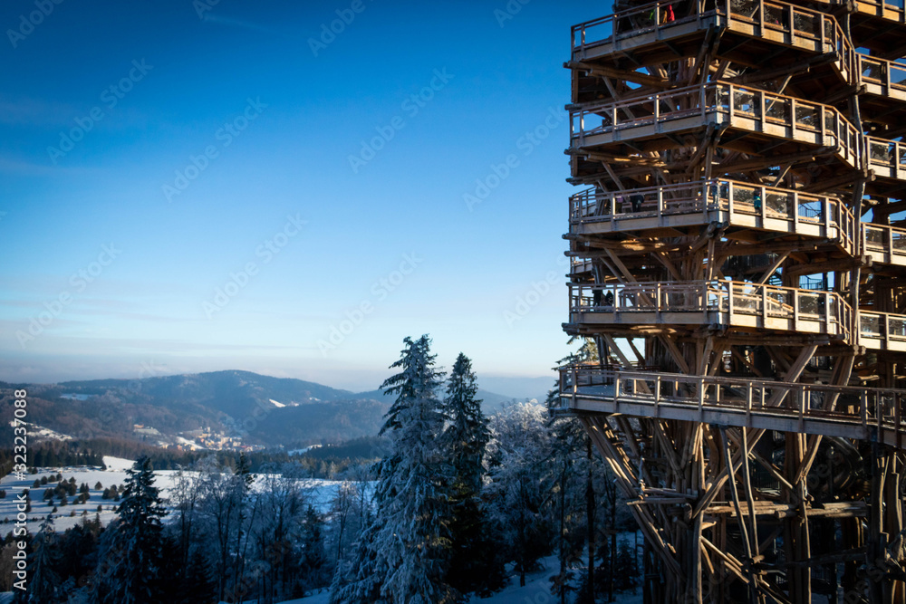 wooden tower construction with snow and ice on it at sunyy day wooden tower construction with snow and ice on it at sunyy day