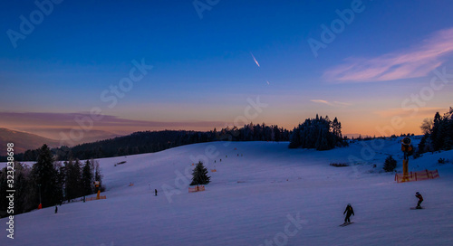 winter eveing in mountain with frozen tress and great sunshine rays