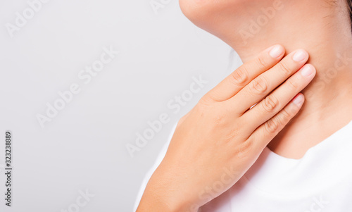 Asian beautiful woman Sore Throat or thyroid gland problem her useing Hand Touching Ill Neck