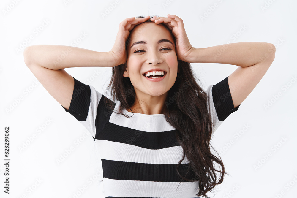 Carefree, upbeat happy asian girl with relaxed delighted smile, holding hands on head and grinning, being in good mood, feeling relieve or happiness, standing white background Carefree, upbeat happy asian girl with relaxed delighted smile, holding hands on head and grinning, being in good mood, feeling relieve or happiness, standing white background