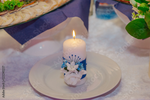 Beautiful candles on the table for the newlyweds on their wedding day.