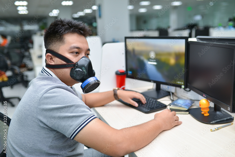 Office workers wear respirators/ gas masks instead of medical masks, the disease caused by coronavirus nCoV/Covid-19 has caused scarcity of medical equipment Office workers wear respirators/ gas masks instead of medical masks, the disease caused by coronavirus nCoV/Covid-19 has caused scarcity of medical equipment