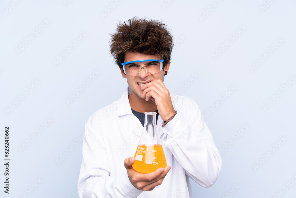 Young scientific man over isolated blue background nervous and scared Young scientific man over isolated blue background nervous and scared