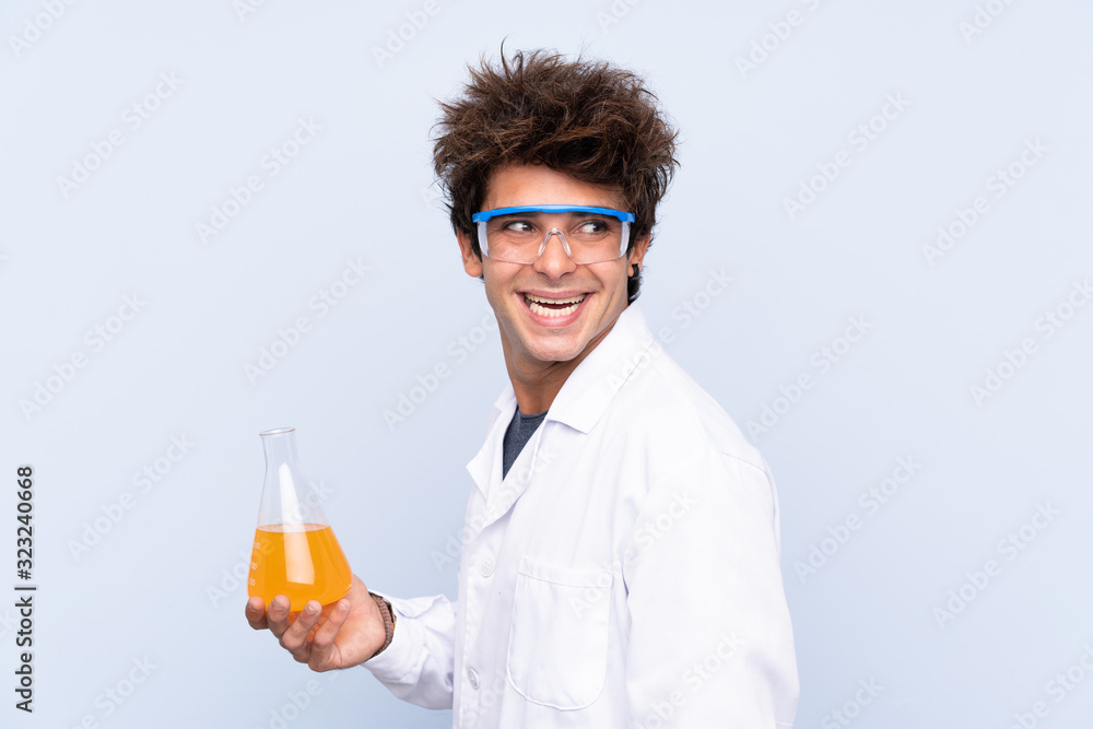 Young scientific man over isolated blue background laughing Young scientific man over isolated blue background laughing