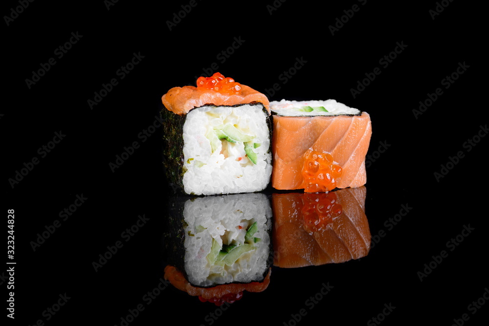 roll with salmon on a black background with insulation and reflection roll with salmon on a black background with insulation and reflection