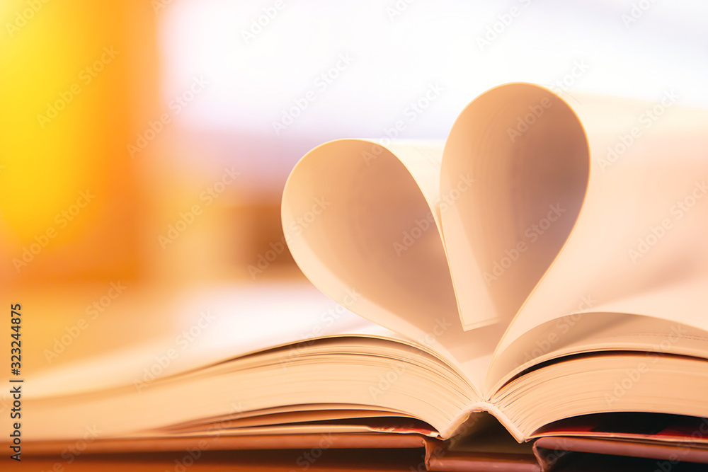 Close up book image in heart shape on the table at library room of lifestyle love to read and february valentine day concepts. Close up book image in heart shape on the table at library room of lifestyle love to read and february valentine day concepts.
