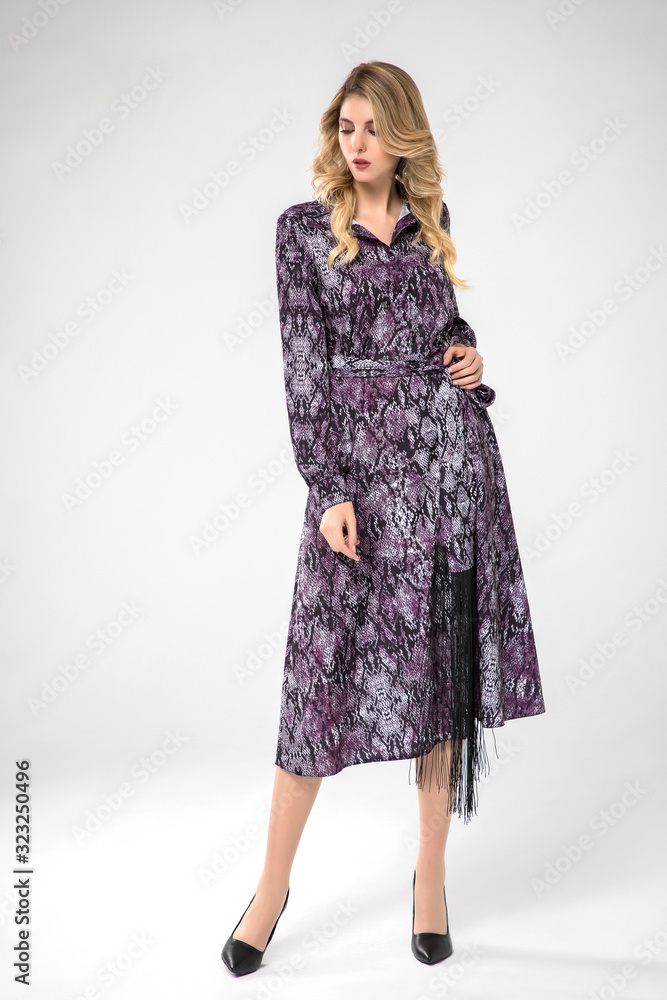 beautiful blonde model posing in long chic purple dress. white background. beautiful blonde model posing in long chic purple dress. white background.