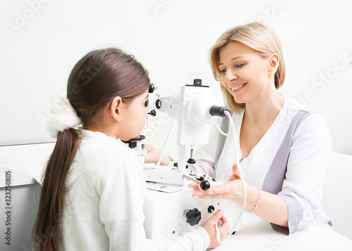 Ophthalmologist performs strabismus checkup using synoptophore. Strabismus treatment of a girl patient