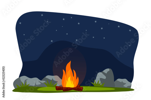 Bright sparkling burning bonfire on field at night