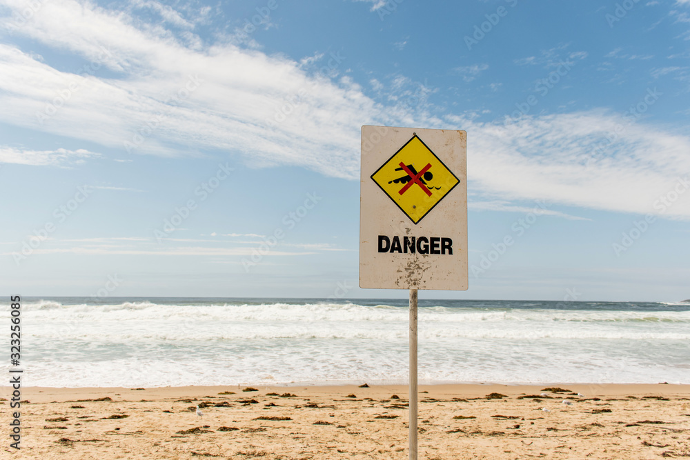 Danger sign for swimmers at the beach in Australia